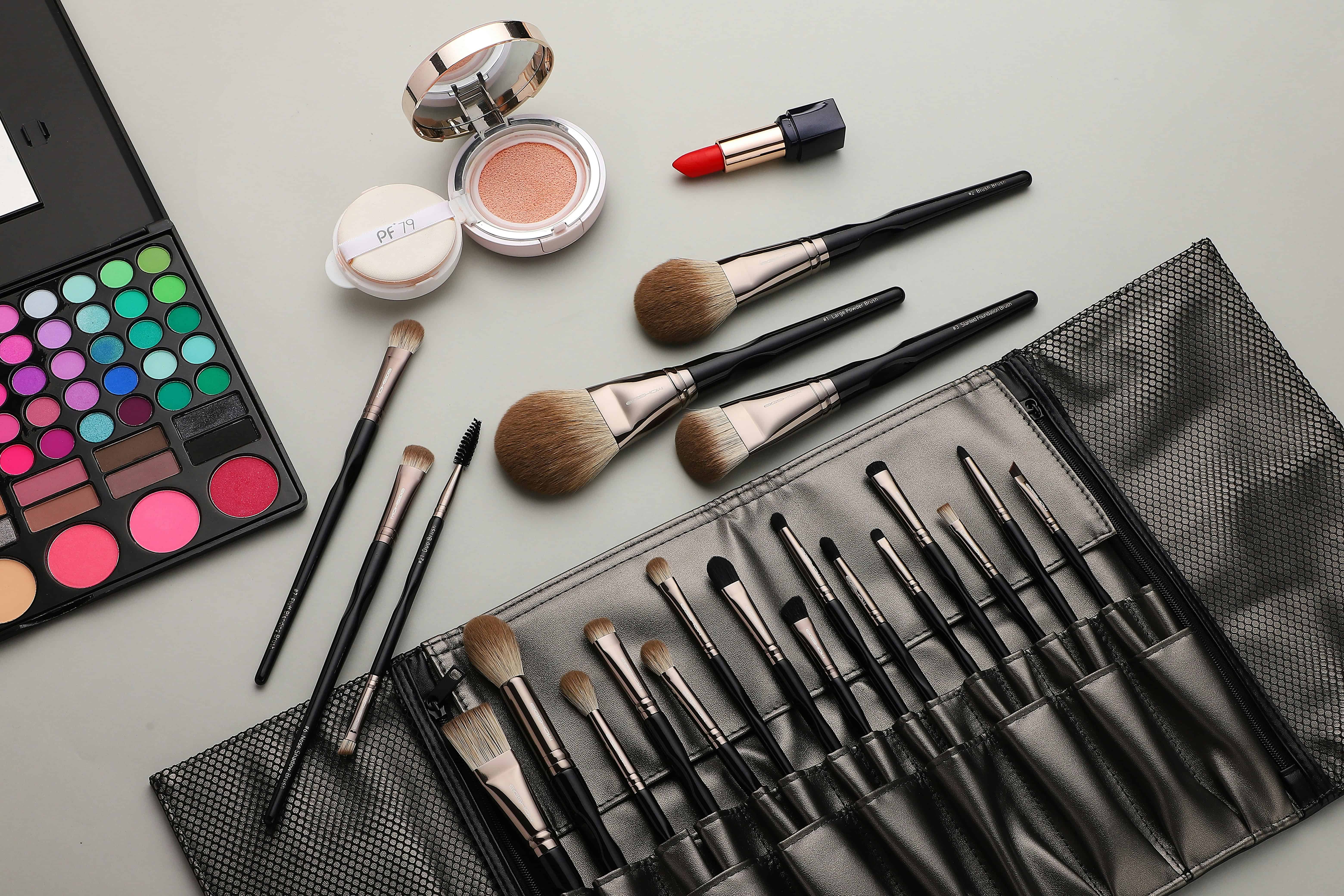Flat lay of professional makeup palettes and brushes arranged for bridal makeup application.
