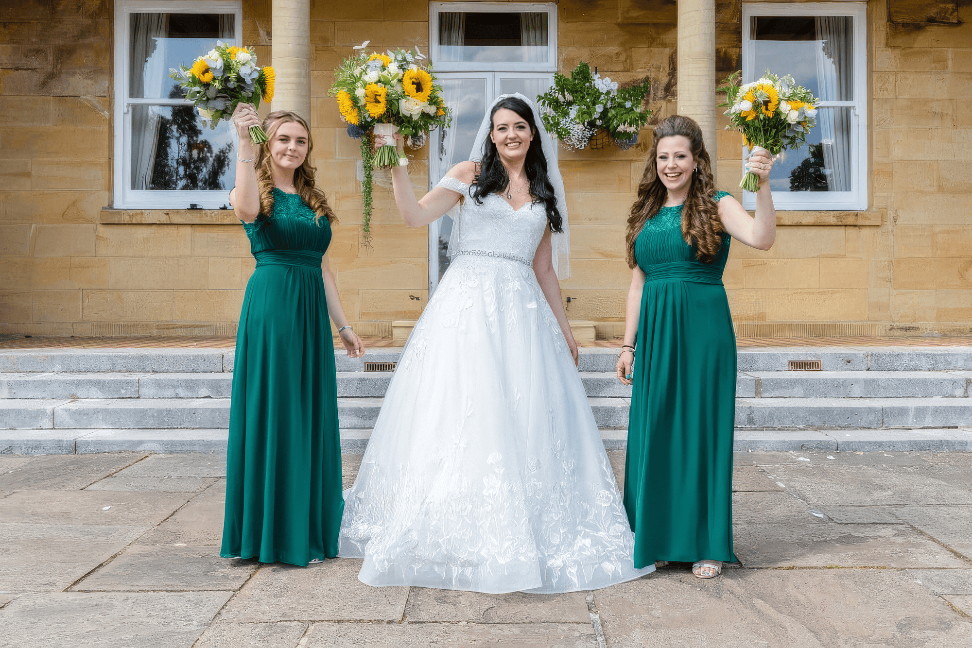 glamour-brides-claire-salomons-estate-kent-bride-and-bridesmaids.jpg Bride with bridesmaids in green dresses holding bouquets at Salomons Estate